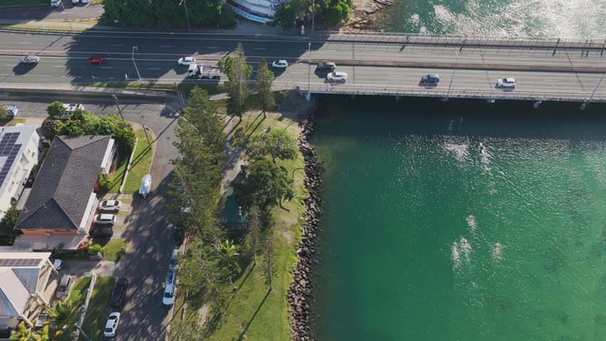 Pedestrians And Traffic At Tallebudgera Creek Bridge On Gold Coast Highway In Queensland, Australia. aerial sideways shot
