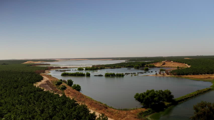 Drone view of a River running through farmland in Modesto, California