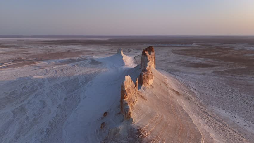 Aerial view of Bozzhyra View Point 1 featuring white chalk cliffs and vast desert plateaus under a soft morning light in Karakiya District, Mangystau Region, Kazakhstan.