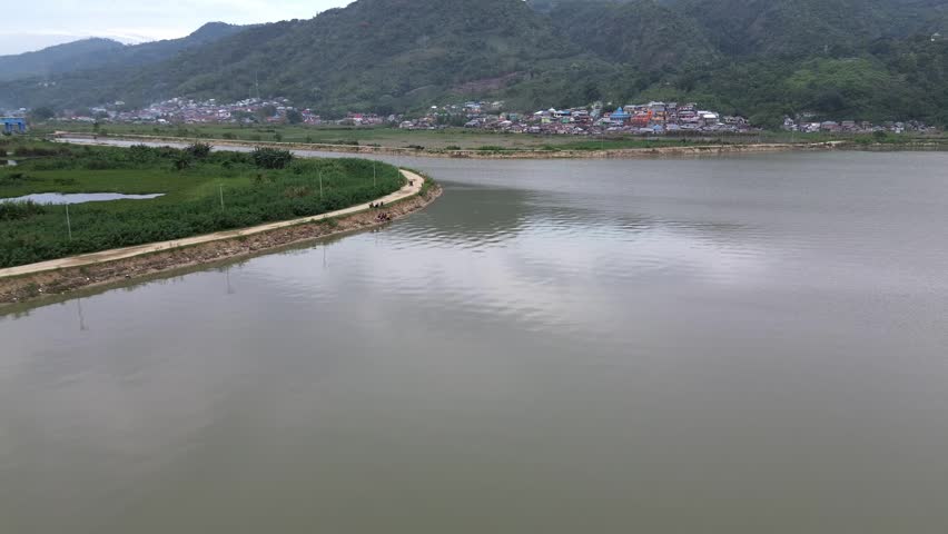 Scenic View of a Lakeside Town and Mountains