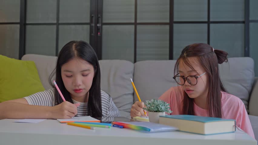 Two Asian girl using tablet search information for report