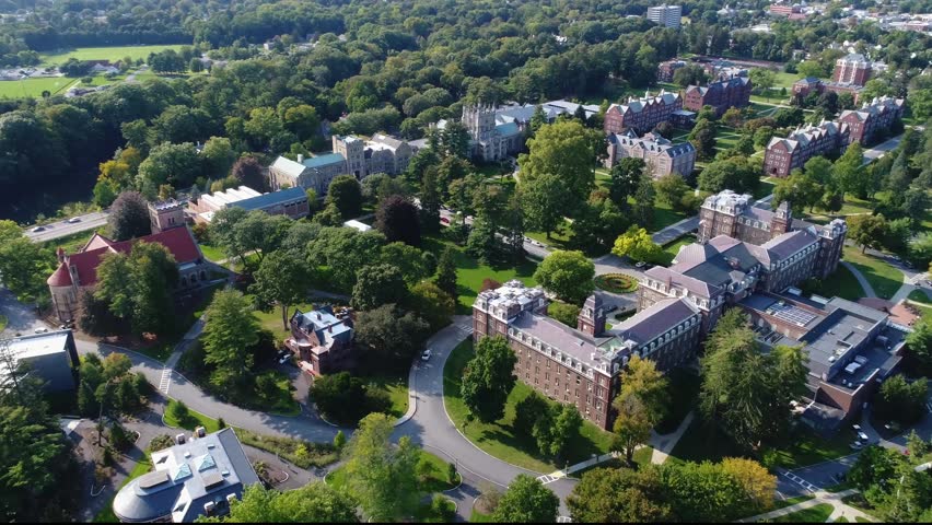 Aerial view of Vassar College campus featuring historic collegiate gothic architecture and lush green trees in Poughkeepsie, New York, United States.