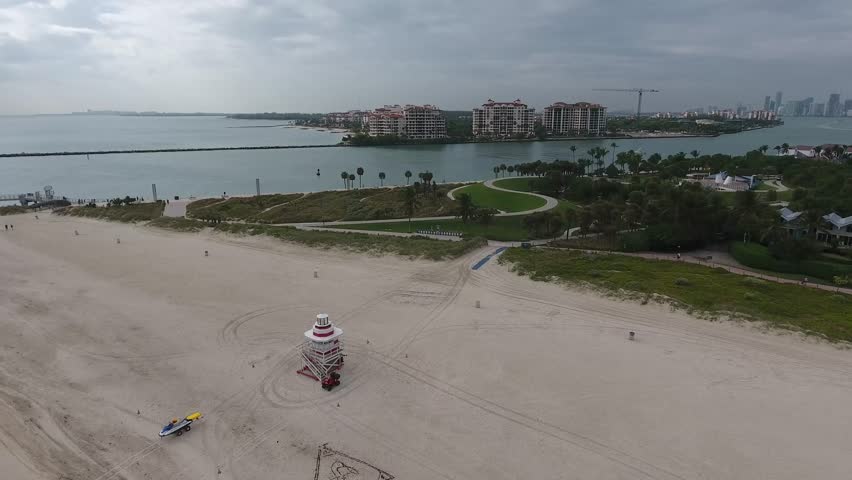 Aerial view of South Beach featuring the iconic lifeguard tower, South Pointe Park greenery, and the Atlantic Ocean coastline in Miami Beach, Florida, United States.