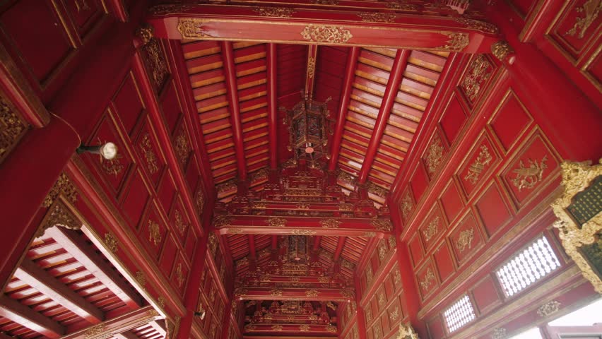 Ornate wooden ceiling of a traditional vietnam temple in the imperial city of hue, a unesco world heritage site.