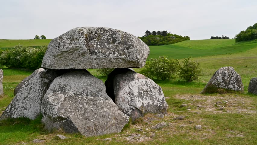 Stone age ruins in a field under cloudy skies.