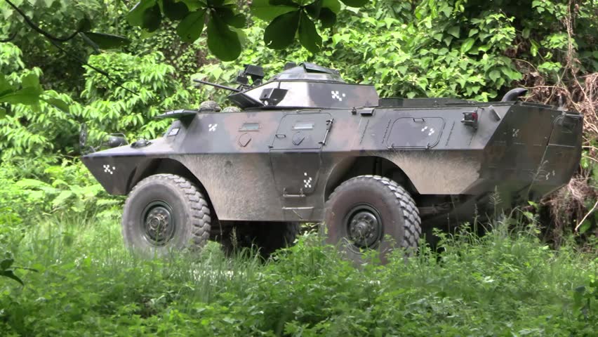 This armored vehicle is a Cadillac Gage Commando, known for its amphibious capabilities. It features a 4x4 drivetrain and was designed for multiple roles, including armored personnel carrier and internal security.