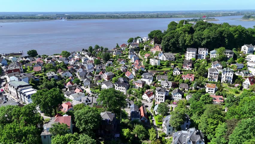 Aerial view of Treppenviertel Blankenese with historic houses and lush green trees overlooking the Elbe river in Hamburg, Hamburg, Germany.