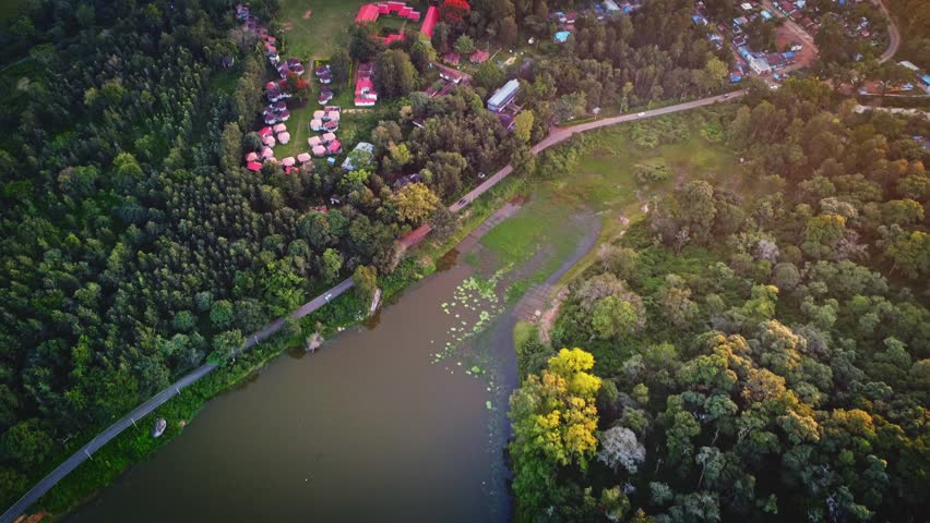 Aerial landscape of the lush green BR Hills near Bangalore, featuring dense forests, rolling hills, and serene water bodies.