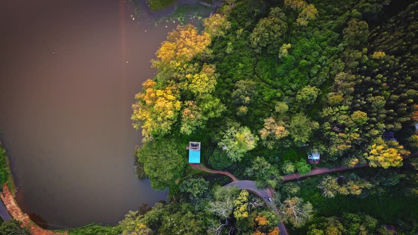 Aerial landscape of the lush green BR Hills near Bangalore, featuring dense forests, rolling hills, and serene water bodies.