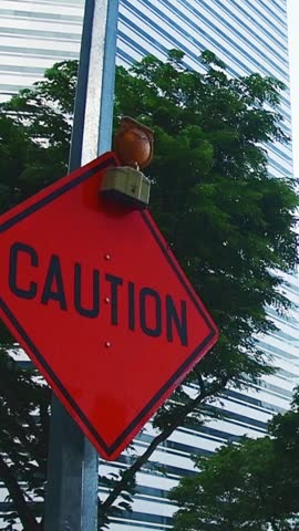 Singapore urban scene with red caution road sign near modern skyscrapers construction warning business district infrastructure. CBD.Caution banner investment and construction road works safety concept