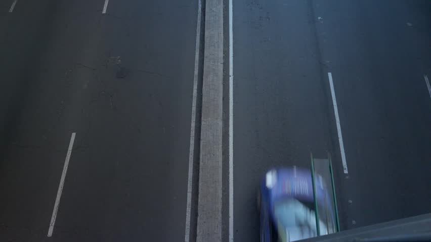 Overhead view of cars passing on a multi-lane highway with median