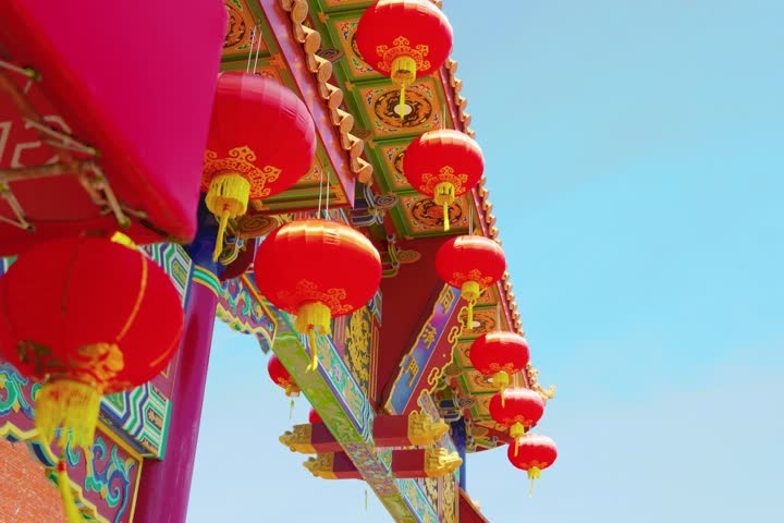 Decorative red lanterns hanging on traditional building exterior