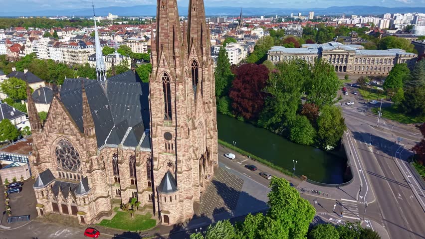 Church of Saint Paul by river with modern European Parliament building in background in Strasbourg, France