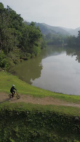 Aerial View of Person Riding Bicycle Near Lake