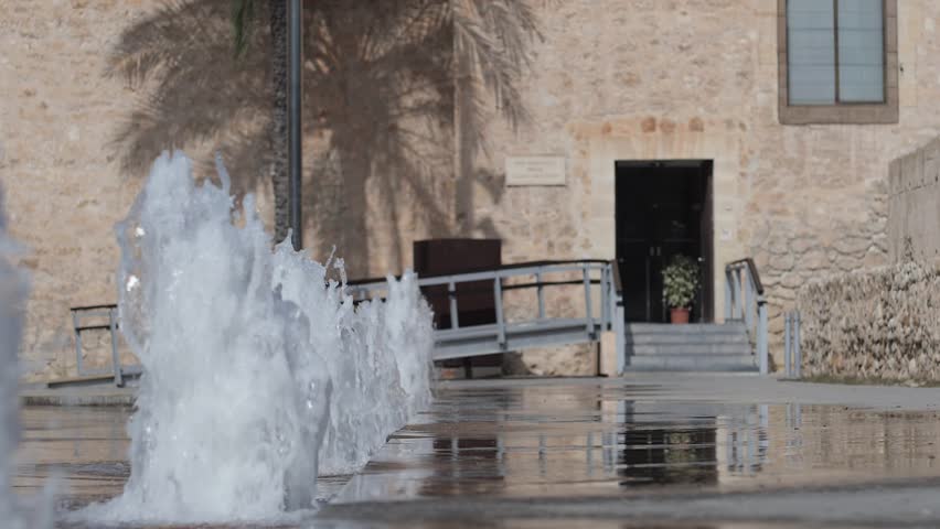 Entrance to the Altamira Palace with the fountains blurred in super slow motion. Elche, Spain.