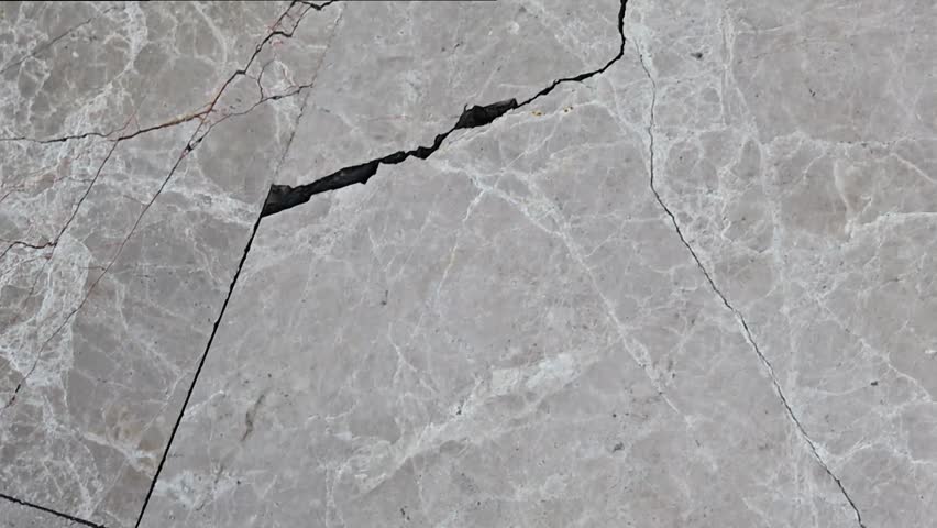 a crack on a tile floor. 