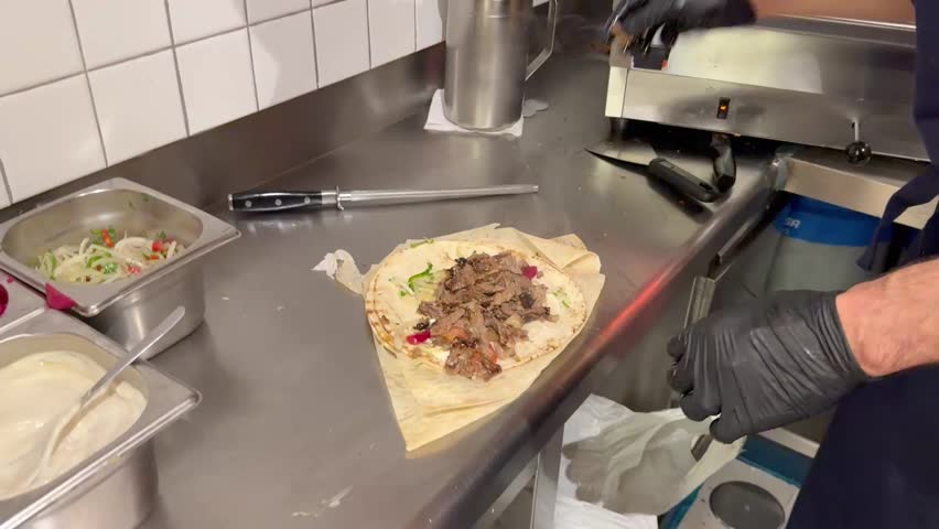 Chef preparing a traditional shawarma wrap