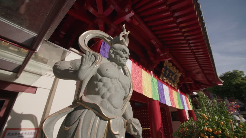 Statues at Buddha Tooth Relic Temple in Singapore. Chinatown architecture, religious statues near the temple, travel to Asia.