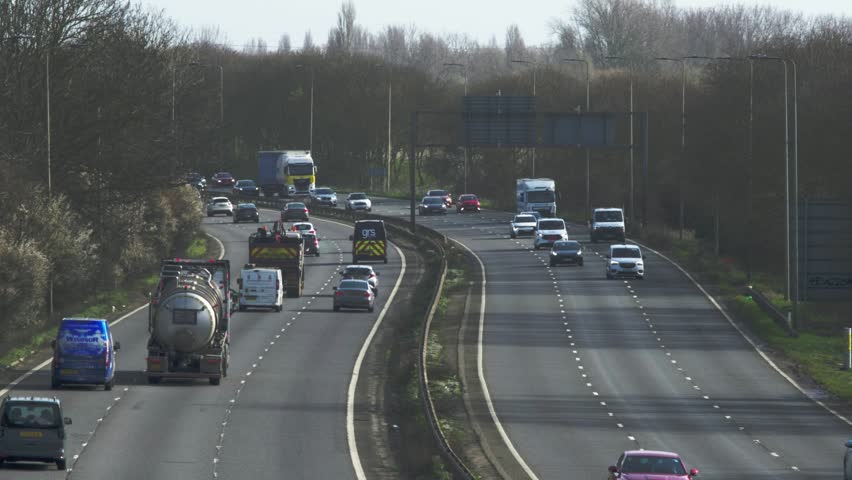 Busy Highway Motorway Traffic With Cars, Vans and Trucks During Daytime Commute on Open Road in England UK