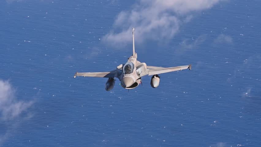 An F-16 Fighting Falcon Soars Majestically on a High-Stakes Maritime Patrol Mission Over Deep Blue Ocean Waters.