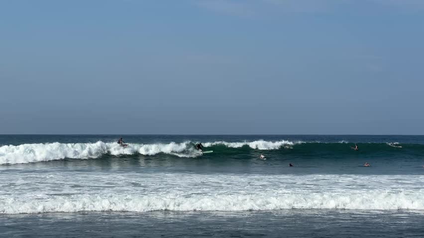 A surfer catches waves in the ocean