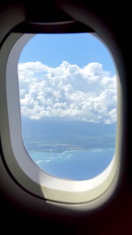 Flying over San Juan, Puerto Rico looking out of a airplane window.