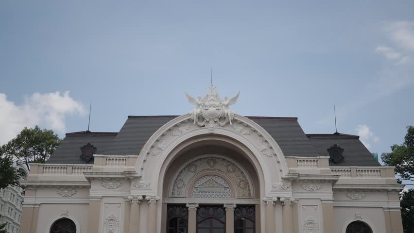 Static cinematic shot of the historic Saigon Opera House facade in Ho Chi Minh City, Vietnam. Elegant French colonial architecture and cultural landmark suitable for travel, tourism, architecture, and heritage concepts.
