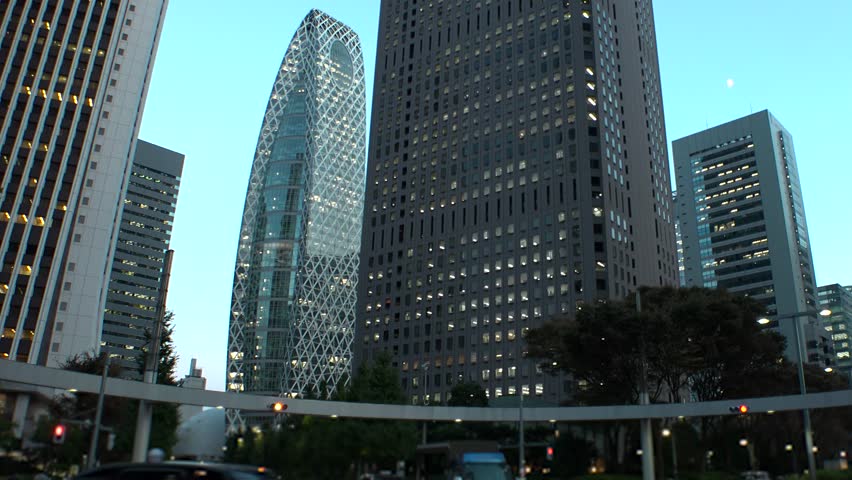 SHINJUKU, TOKYO, JAPAN - JULY 2025 : Cityscape of Tokyo at night, featuring a vibrant business district and towering office buildings. A dynamic and modern urban metropolis scene. Time lapse shot.