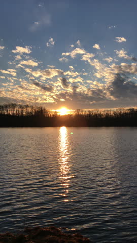 Beautiful Scenic sunset over the forest near the lake creek