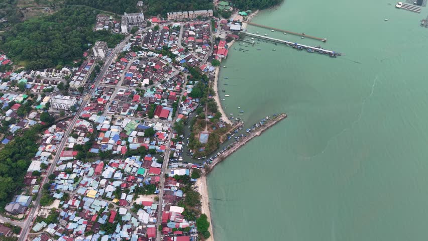 Drone footage showing Teluk Bahang town, residential area, shoreline, piers and boats.