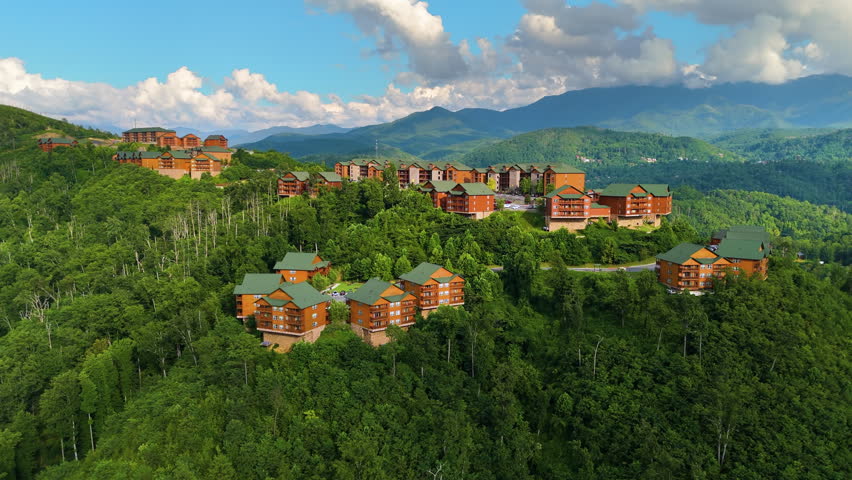 Aerial panorama of mountain residences in Tennessee surrounded by dense forest, winding roads and scenic Appalachian scenery