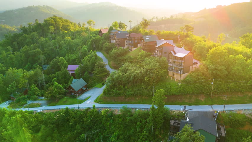 Aerial view of mountain resort houses in Gatlinburg, Tennessee near the Great Smoky Mountains with vibrant greenery and scenic hills
