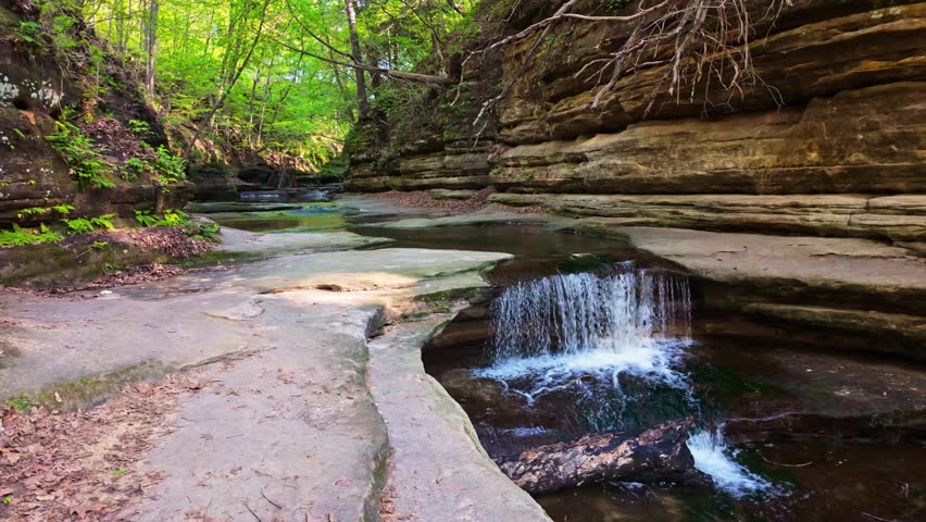 Scenic view of cascading waterfalls flowing through a sandstone canyon in Matthiessen State Park Illinois