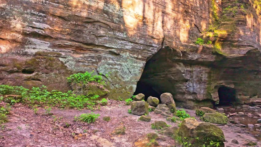 Scenic view of Matthiessen Lake waterfall with a bridge dam spanning the canyon in Matthiessen State Park Illinois