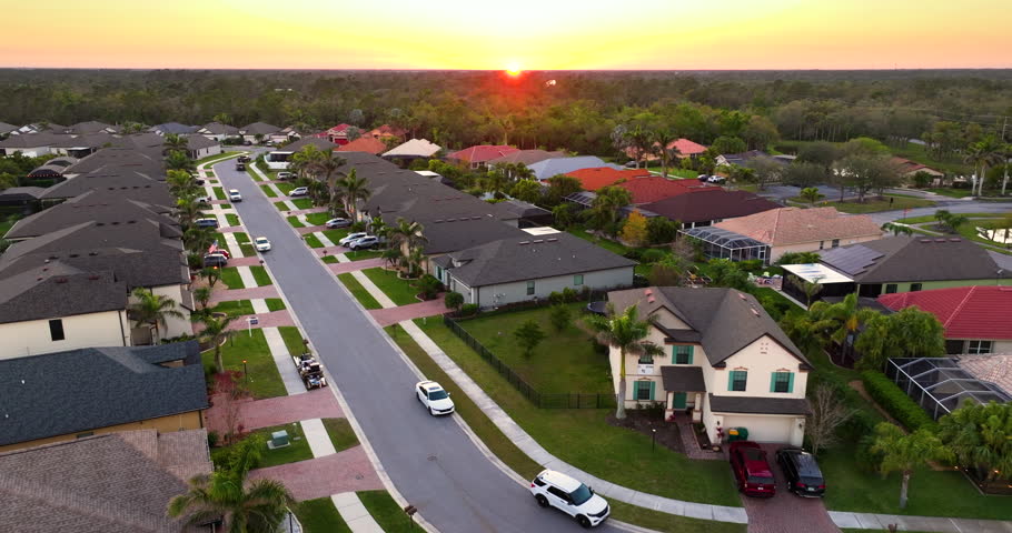 Premium housing development in the USA. Expensive houses between green palm trees in southwest Florida.
