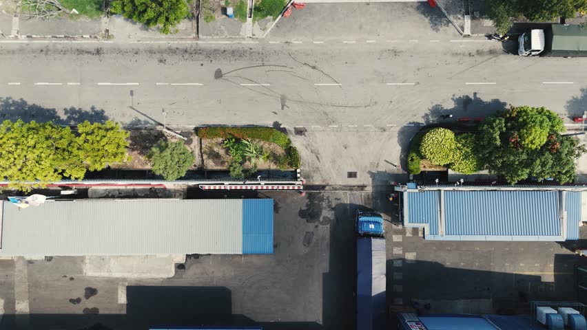 A top-down a loading dock area, showing semi trucks and large shipping.