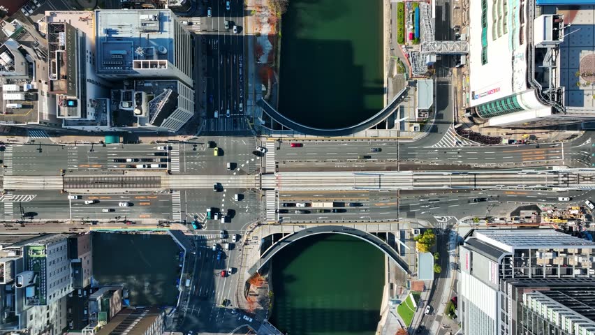 Drone aerial view of a cityscape and roads from directly above.