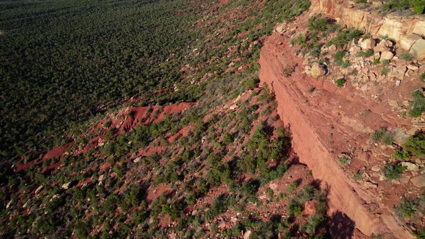 Tilt up revealing drone aerial of cliffs and Bears Ears buttes in Bears Ears National Monument, Utah.