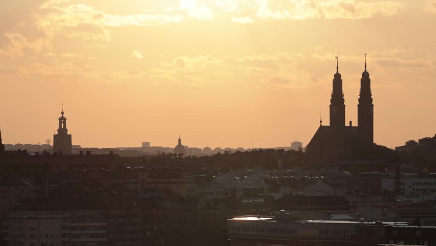 Stockholm, Sweden A skyline view at sunrise and the City Hall or Stadshuset, and the Hogalid Church.