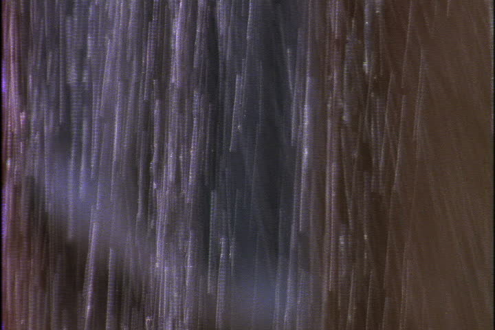 Cascade of water falling into granite basin from the baths at Caracalla in Rome, Italy.