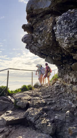 Family at lookout point along Robberg hiking trail in Plettenberg Bay. Vertical