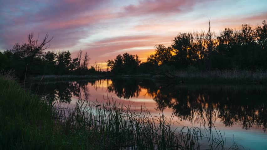 time-lapse, red clouds quickly pass over the lake