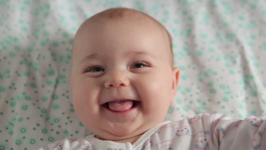Cute baby lies on back and smiling (closeup) Royalty-Free Stock Footage #4093909