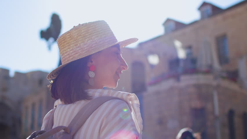 Cheerful woman on a city street in Jerusalem, walking through the Old City. Tourist in Israel