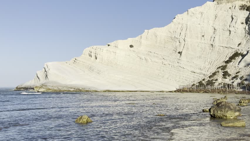sea waves breaking along the white limestone coast of Scala dei Turchi in the morning, Sicily, Italy.