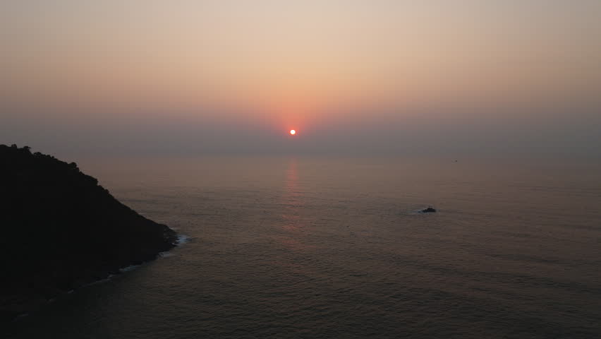 Aerial view of a majestic seascape of sunset sun setting over Indian Ocean