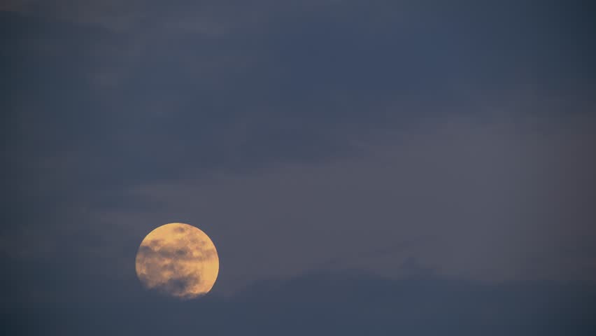 A bright full moon rising in the dark night sky over Shimen, New Taipei, Taiwan, captured during a clear evening.