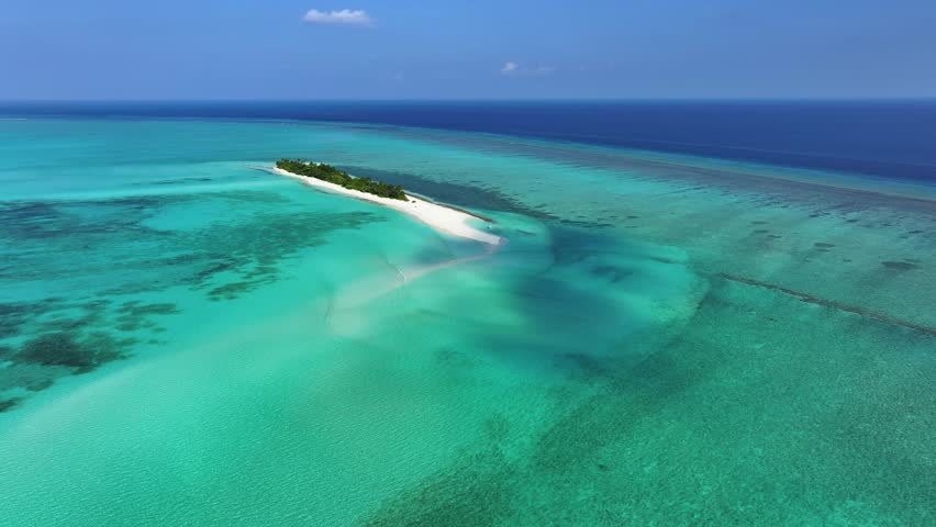 Aerial view of the tropical island of Fulhadhoo with white sand beaches and turquoise coral reefs in the Indian Ocean, Fulhadhoo, Baa Atoll, Maldives.