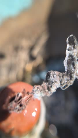 High-quality 4K macro footage of a clean water stream shooting out from a small hole in a fountain. Crisp details of water texture, splashes, and fluid motion. Ideal for concepts related to purity, nature, zen, hydration, plumbing, or abstract liquid backgrounds.
