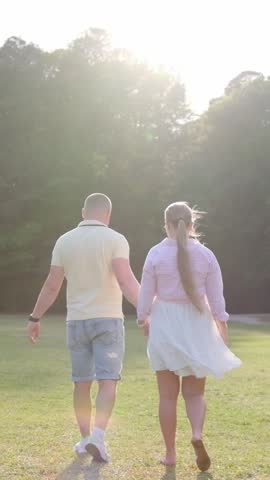 walking and dancing in a park at sunset